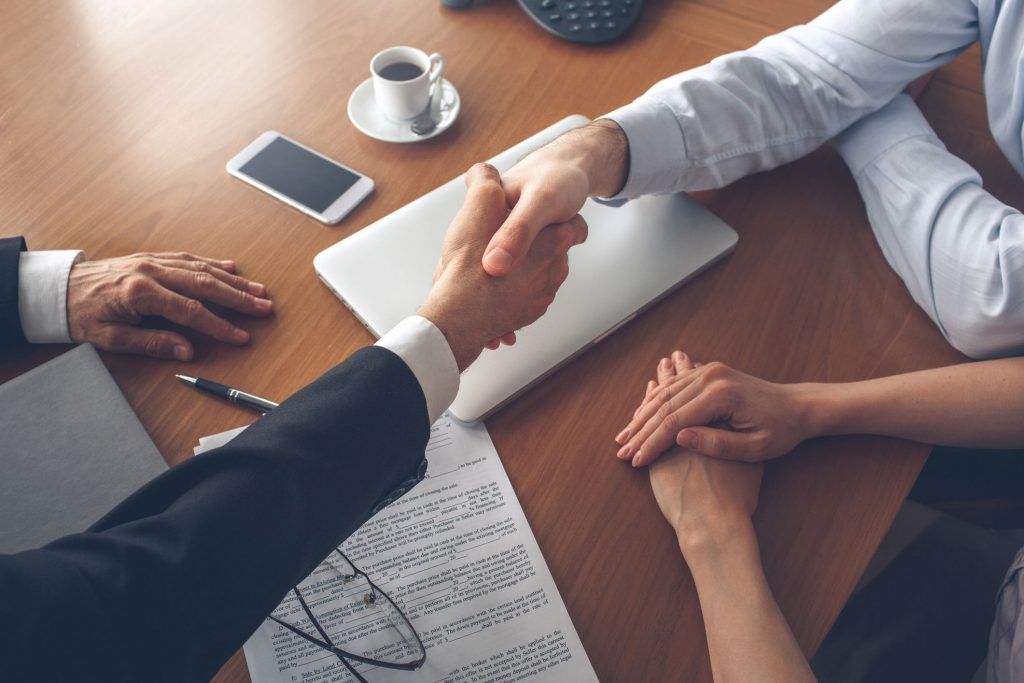 Young couple consultation with agent purchase rent property real estate handshake