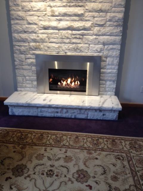 fireplace with stone mantel installed by ener-g tech, inc.