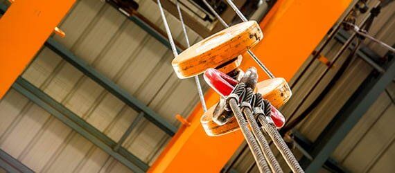 Orange Crane Pulley — Crane Service in Olive, MS Orange Crane Pulley — Crane Service in Olive, MS