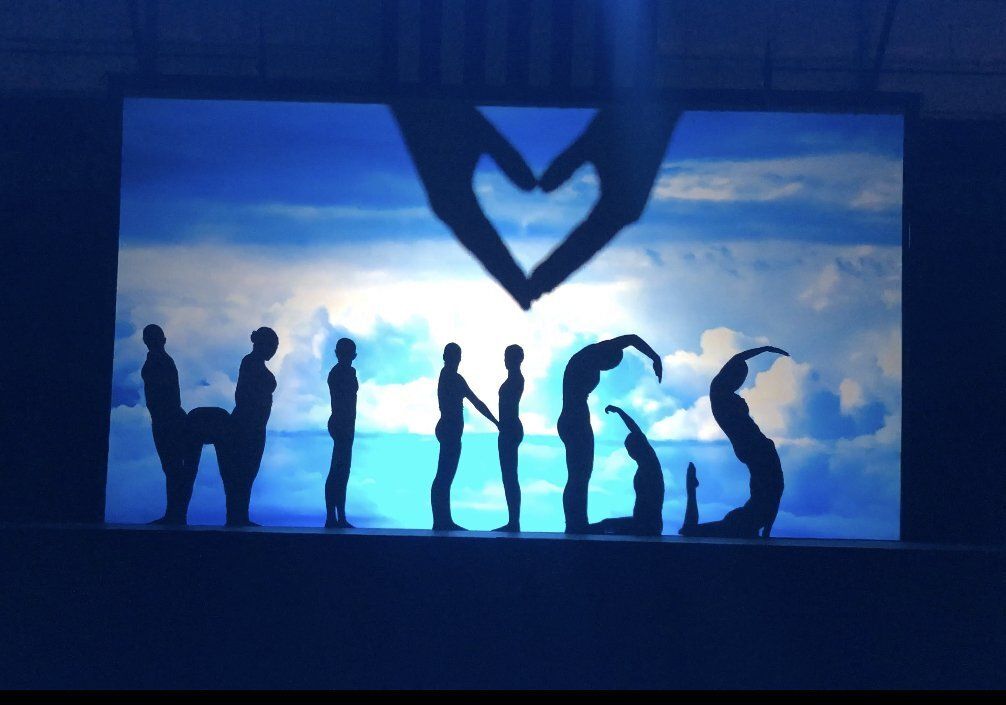 Silhouetted people spelling “I ♥ CSS” against a blue sky at dusk