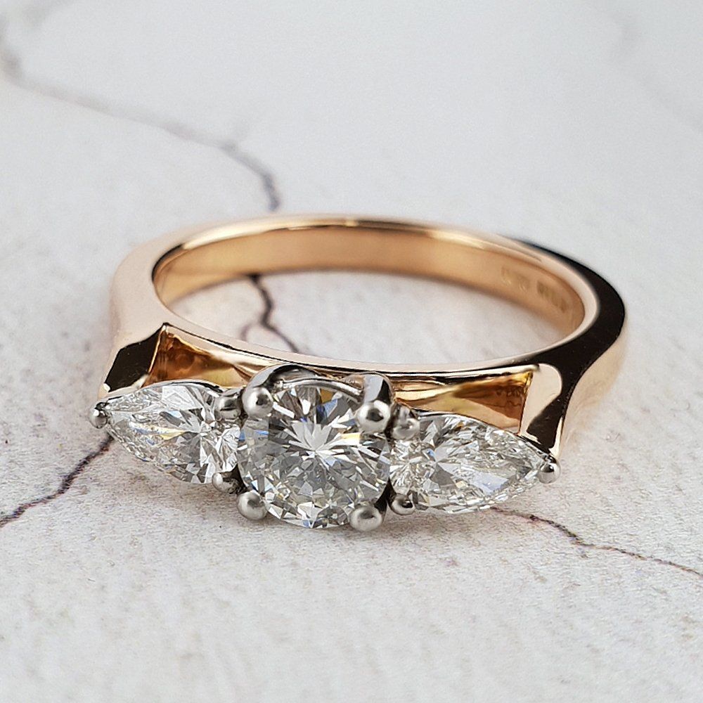 Diamond trilogy ring with round centre and two pe