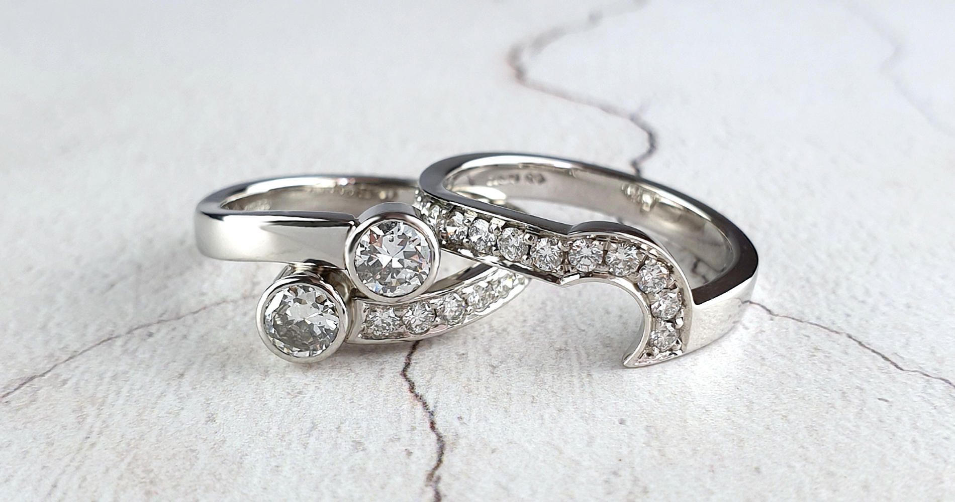 A crossover engagement ring shown with a bespoke fitted wedding ring