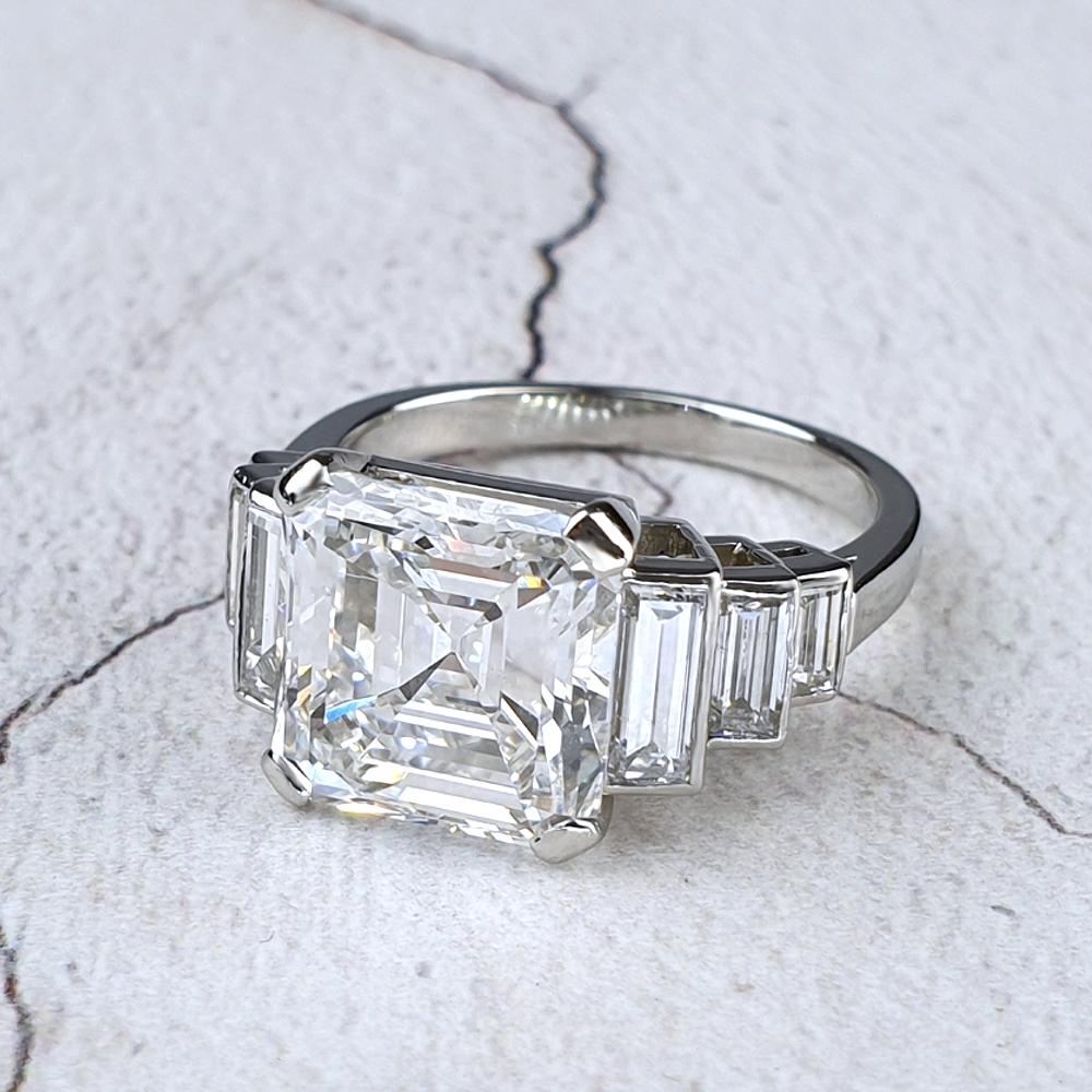 A platinum engagement ring with a large emerald-cut diamond