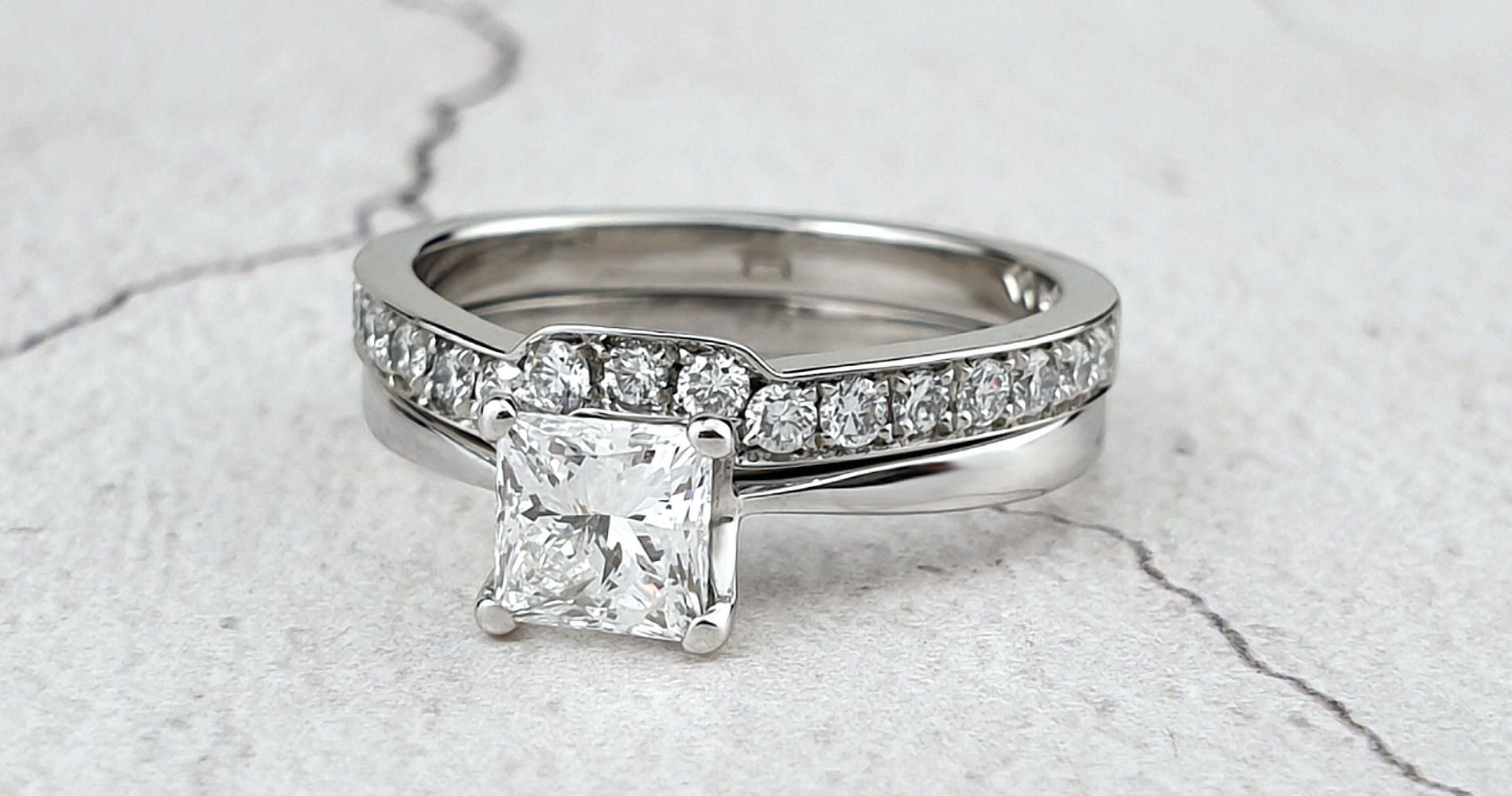 A princess cut diamond engagement ring with a bespoke wedding ring made to fit it