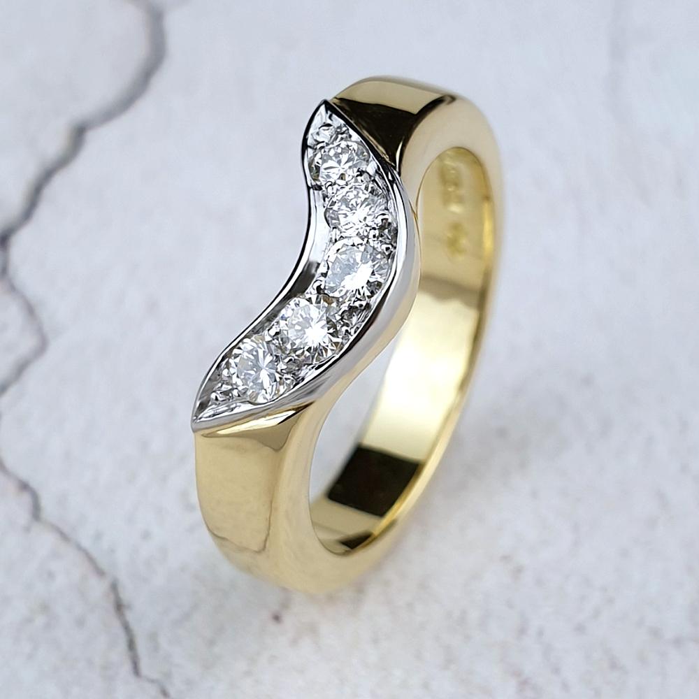 A bespoke fitted wedding ring in yellow gold with diamonds set in platinum