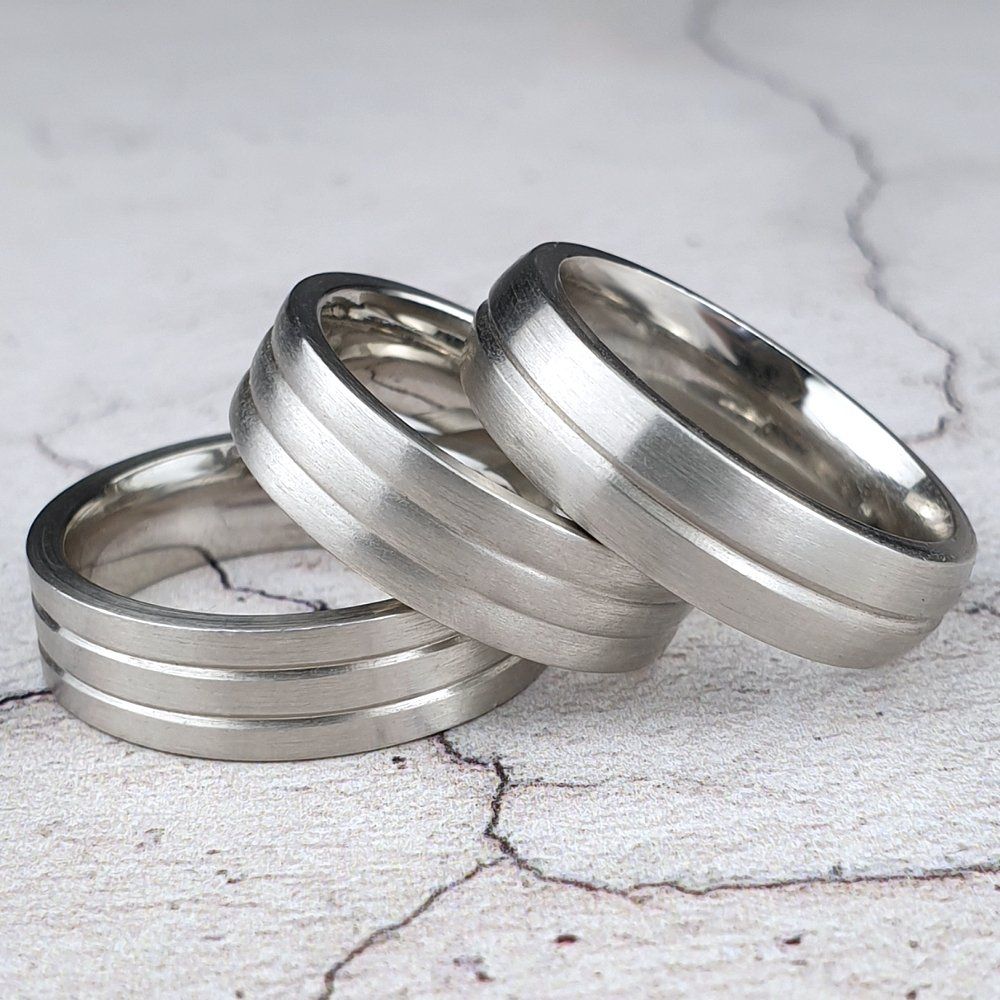 Mans platinum wedding rings with grooved cut around