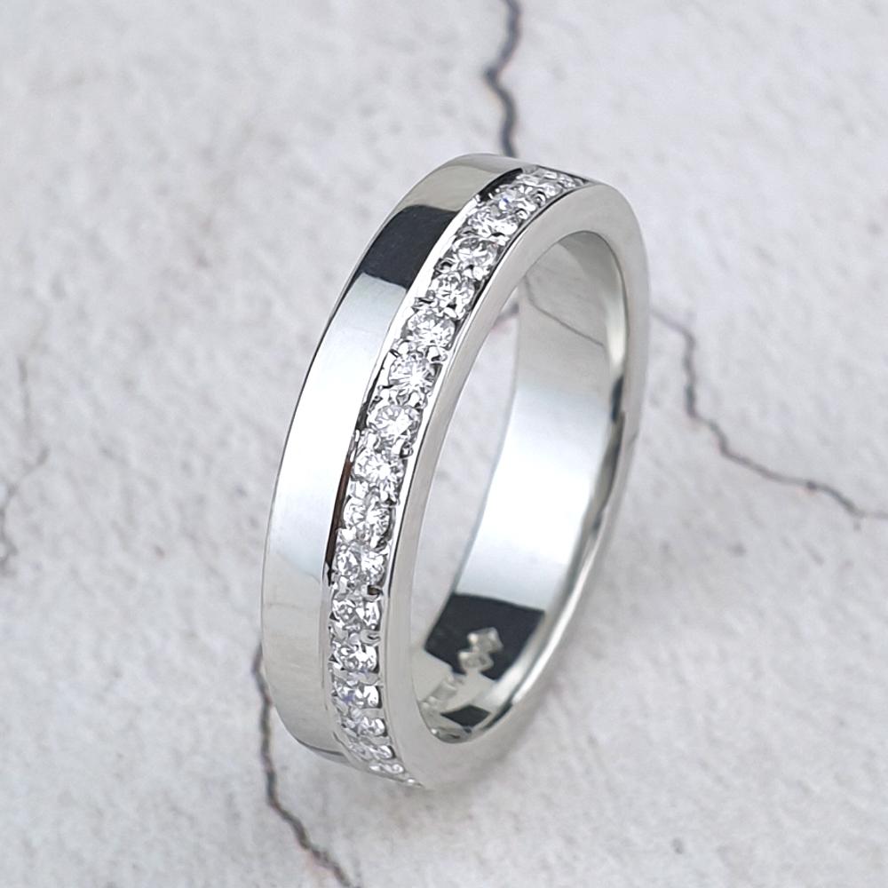 Platinum band with micro-pavé diamonds on one half