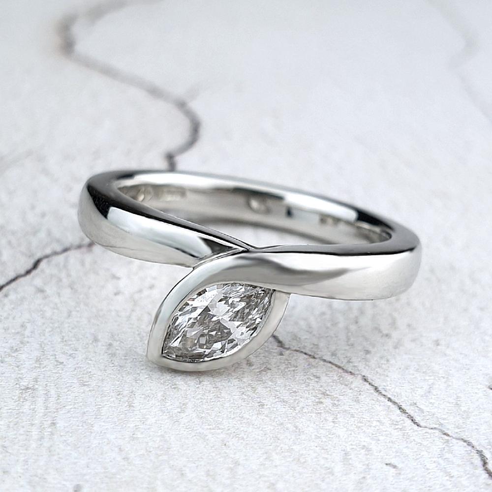 Infinity engagement ring with marquise diamond set diagonally Contemporary engagement ring with marquise diamond
