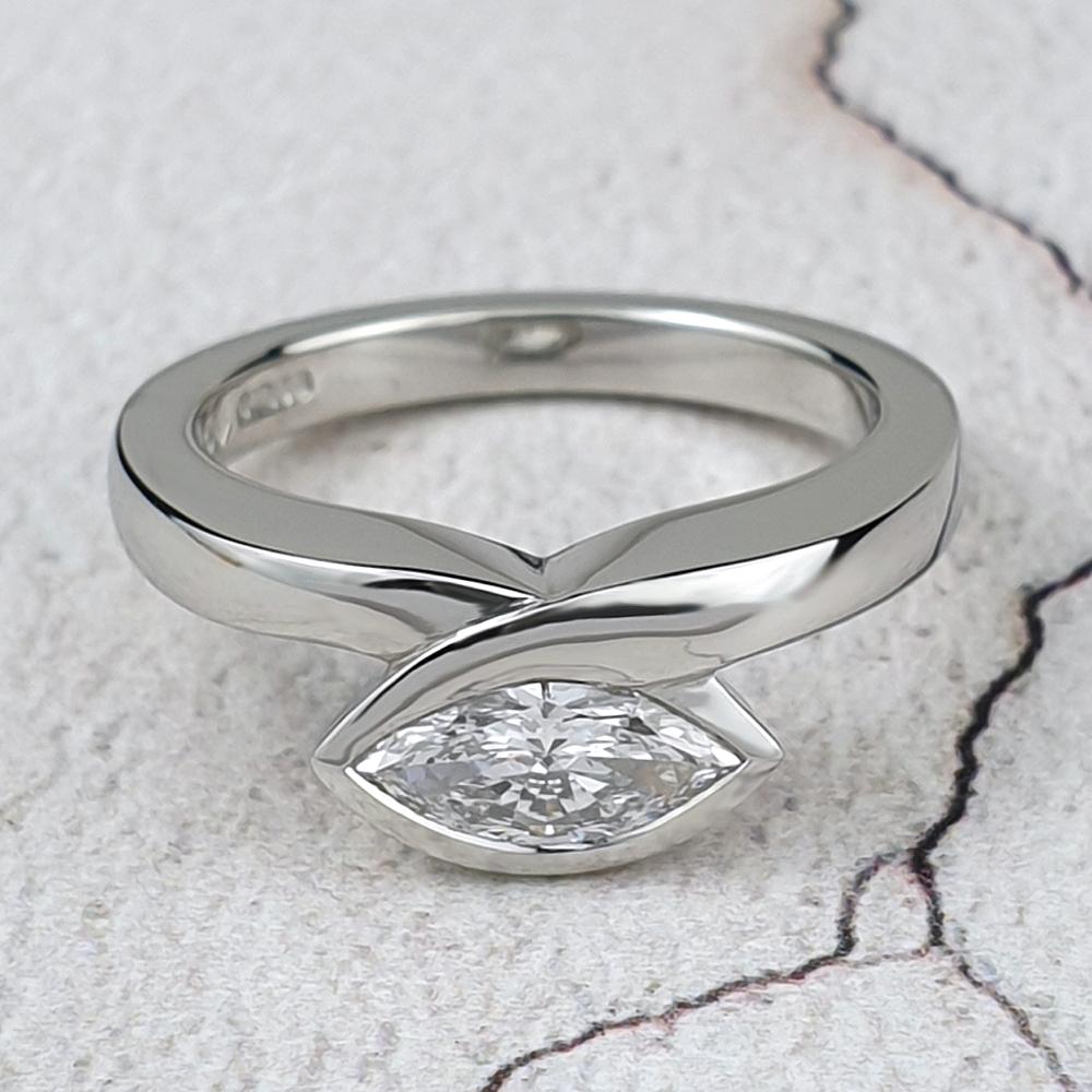 A marquise diamond set horizontally acrossd the finger in a chunky platinum Infinity ring