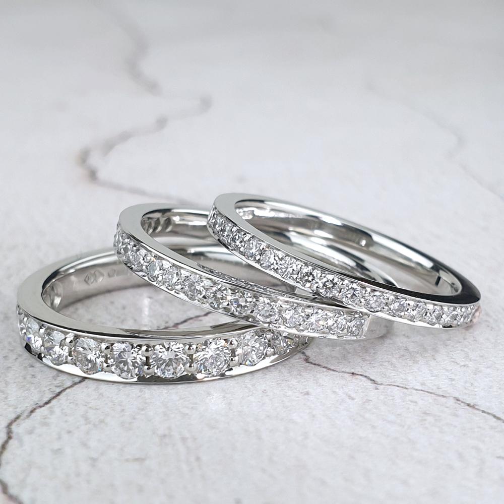 Three platinum wedding rings with micro-pavé diamonds