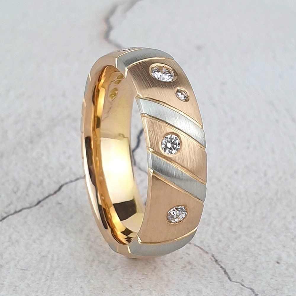 A 5mm wide red gold band with platinum stripes and diamonds