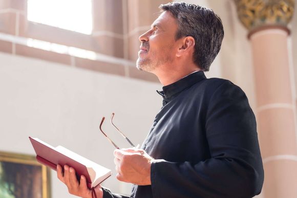 pastor with looking hopeful at the window