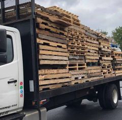 Surplus used pallets loaded on flatbed truck for pickup in NJ