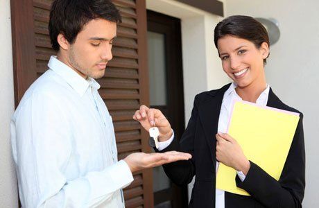 a lady giving a house key