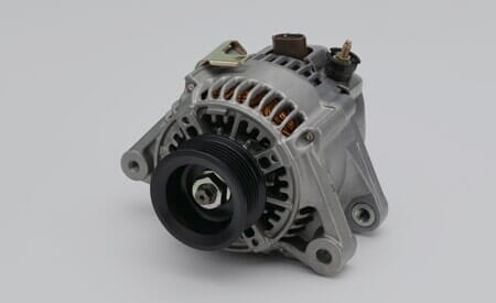 Silver car alternator with black pulley and brown wiring.