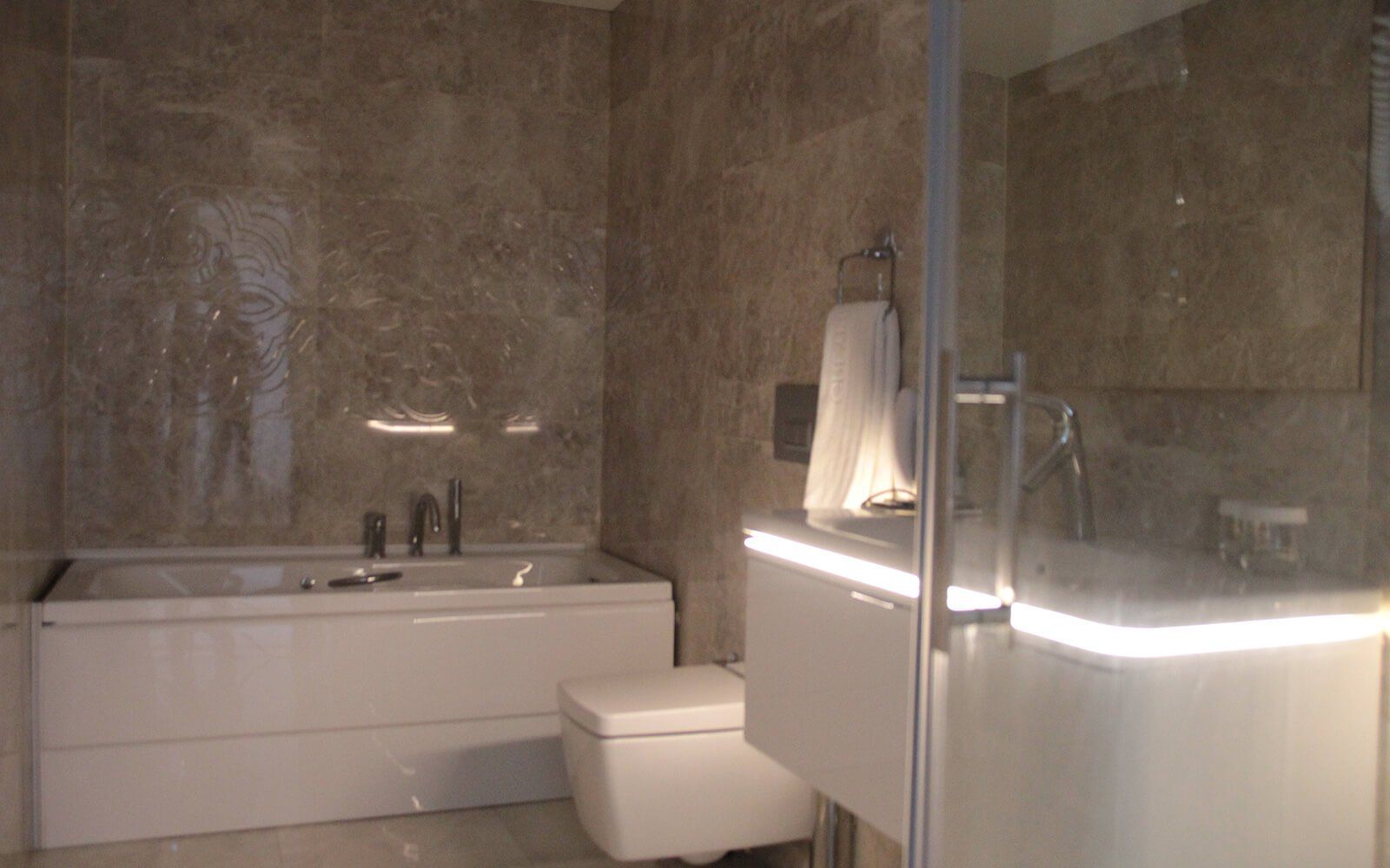 A bathroom with a bathtub , toilet , and shower.