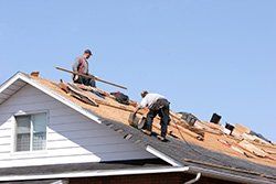 Roof repair — Roofer Working on Exterior of New Home in Columbus, OH