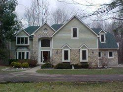 Re Roof — Luxury House With Blue Roof in Columbus, OH