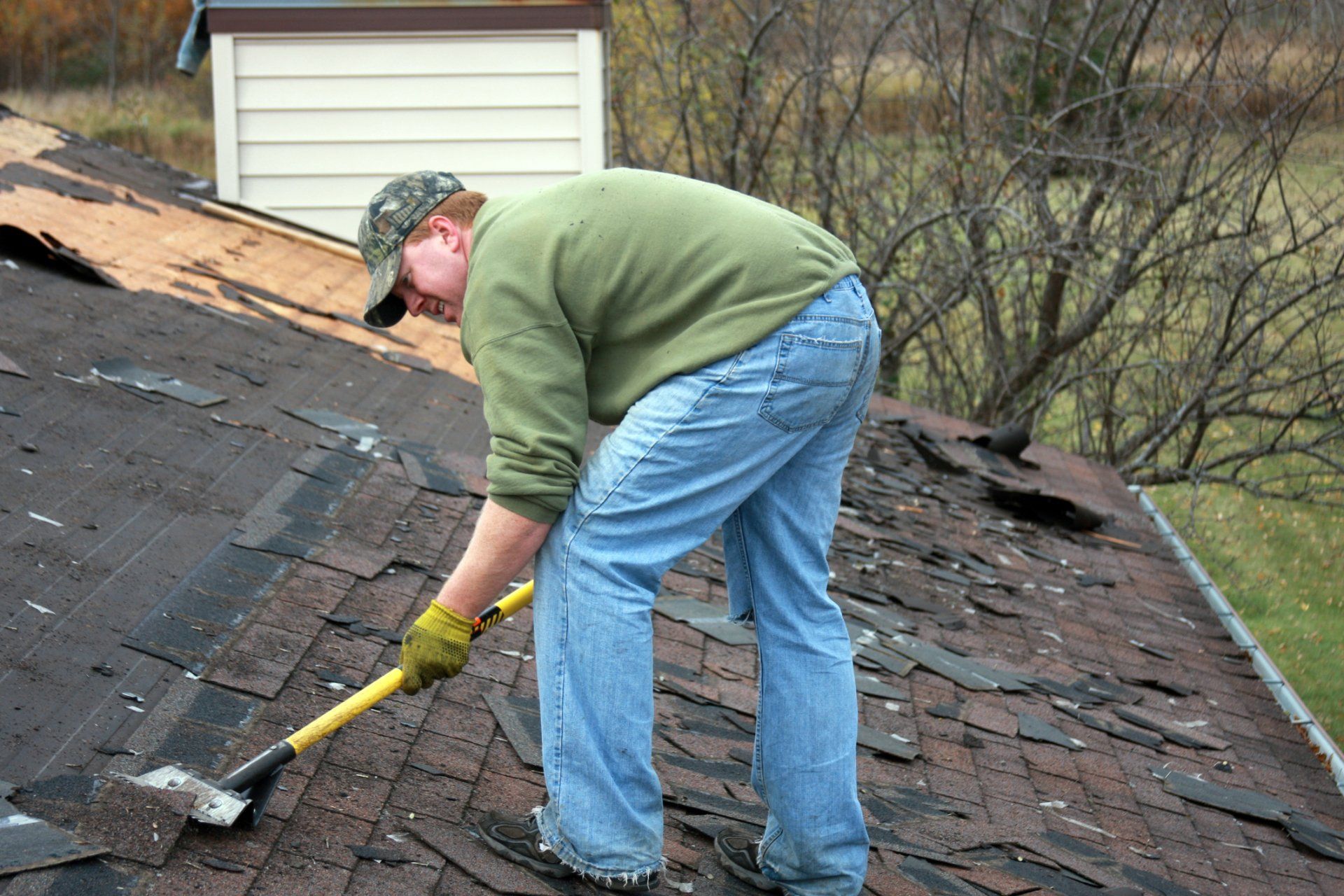 Roofers — Man Removing Old Shingles in Columbus, OH