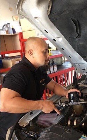 Mechanic Examining Underside of Car — La Porte, TX — Kwik Kar Oil & Brake Mechanic Examining Underside of Car — La Porte, TX — Kwik Kar Oil & Brake