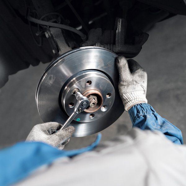 Car Mechanic Hands Replace Brakes — La Porte, TX — Kwik Kar Oil & Brake Car Mechanic Hands Replace Brakes — La Porte, TX — Kwik Kar Oil & Brake