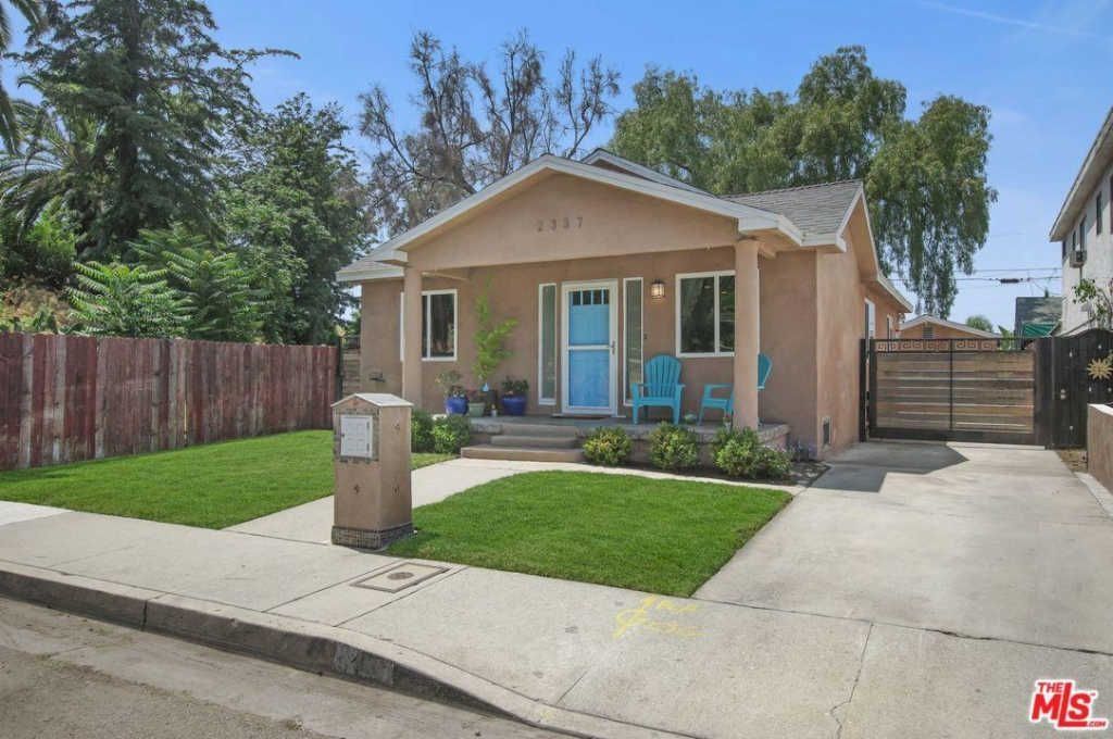 A house with a blue door is for sale