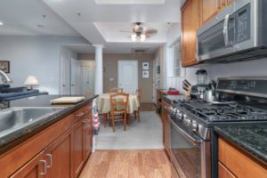 A kitchen with a stove , sink , and microwave.