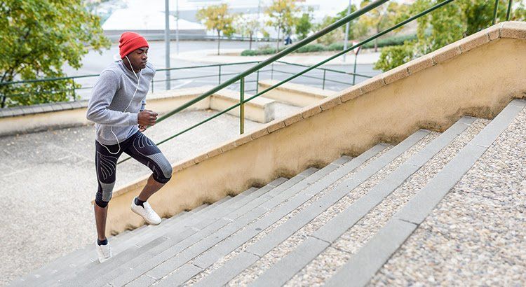 A man is running up a set of stairs.