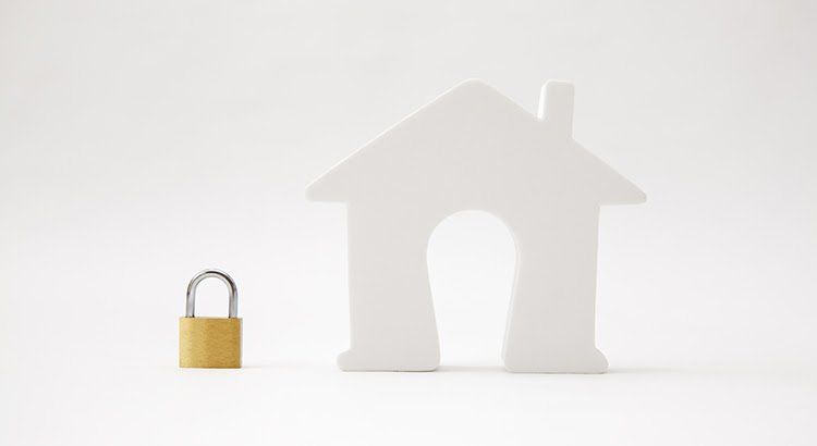 A white house with a padlock next to it.