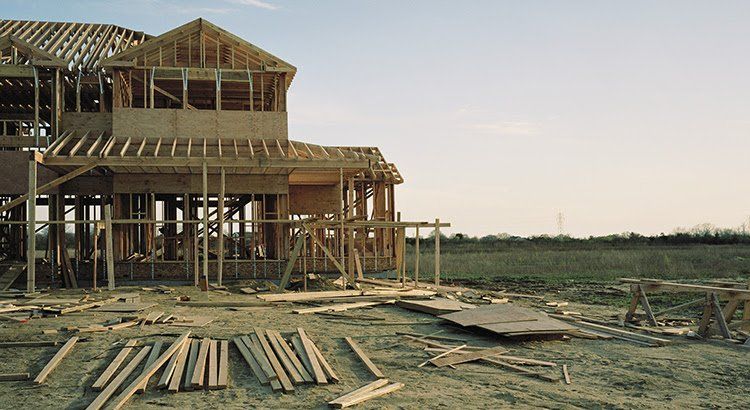 A house is being built in the middle of a field
