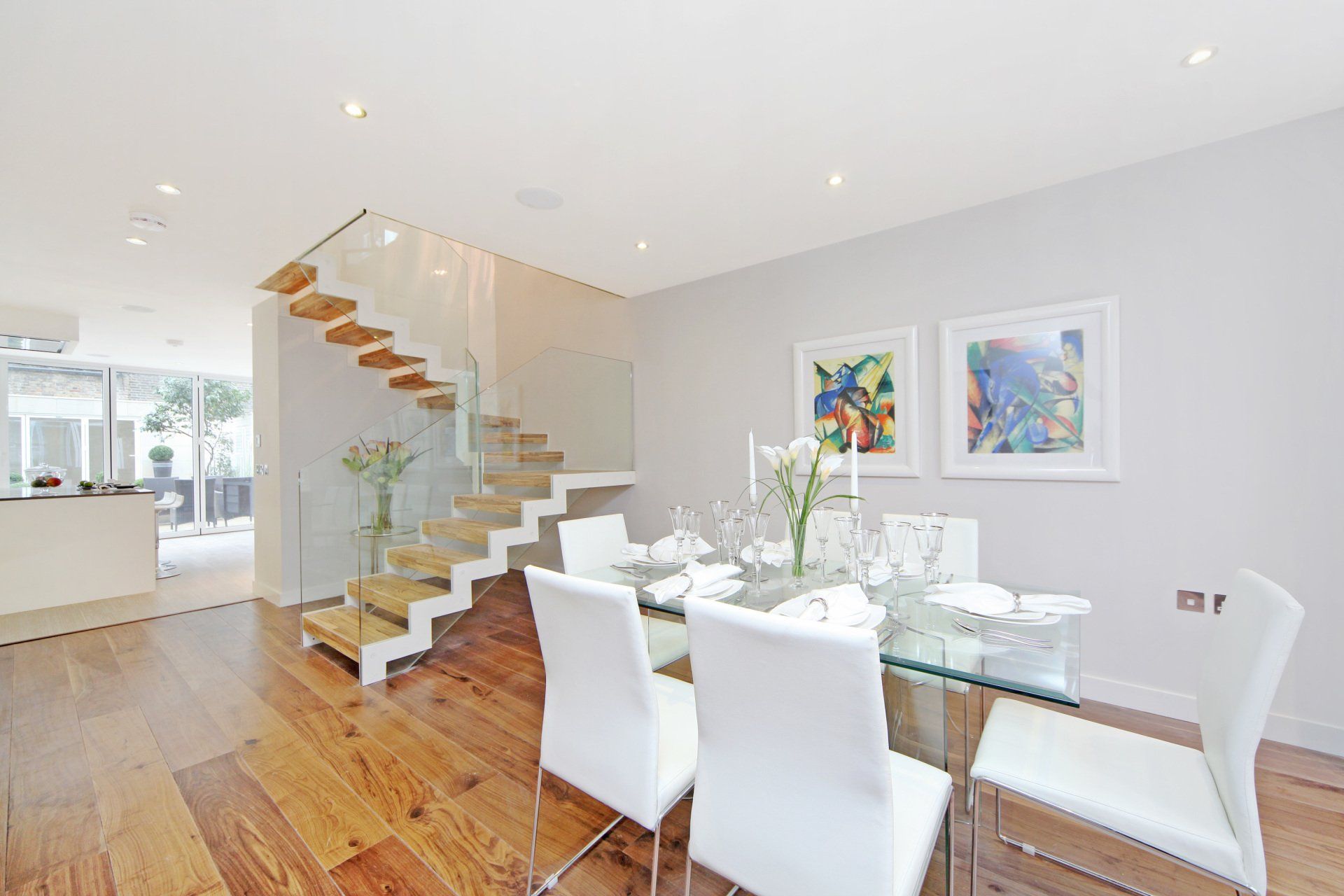 Multi-storey extension with glass staircase balustrades