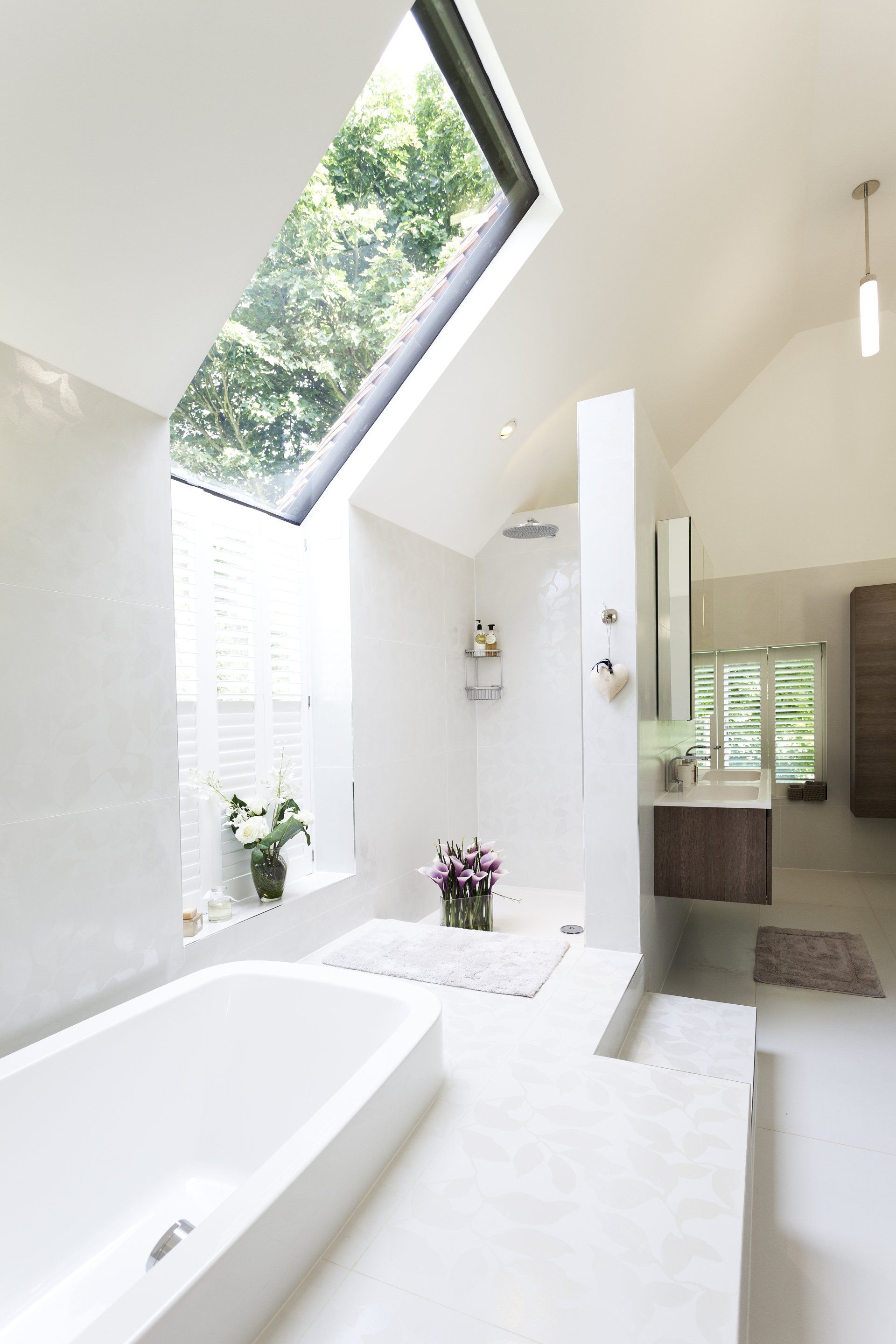 Modern bathroom with unique levels and bath