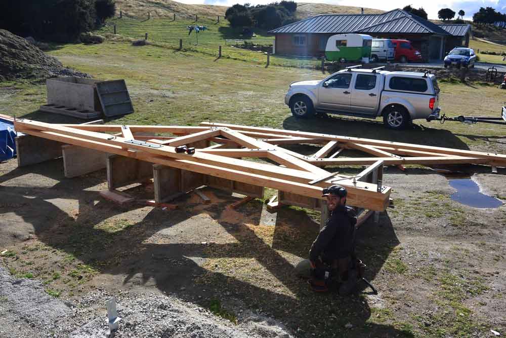 carpenter in front of wooden frame