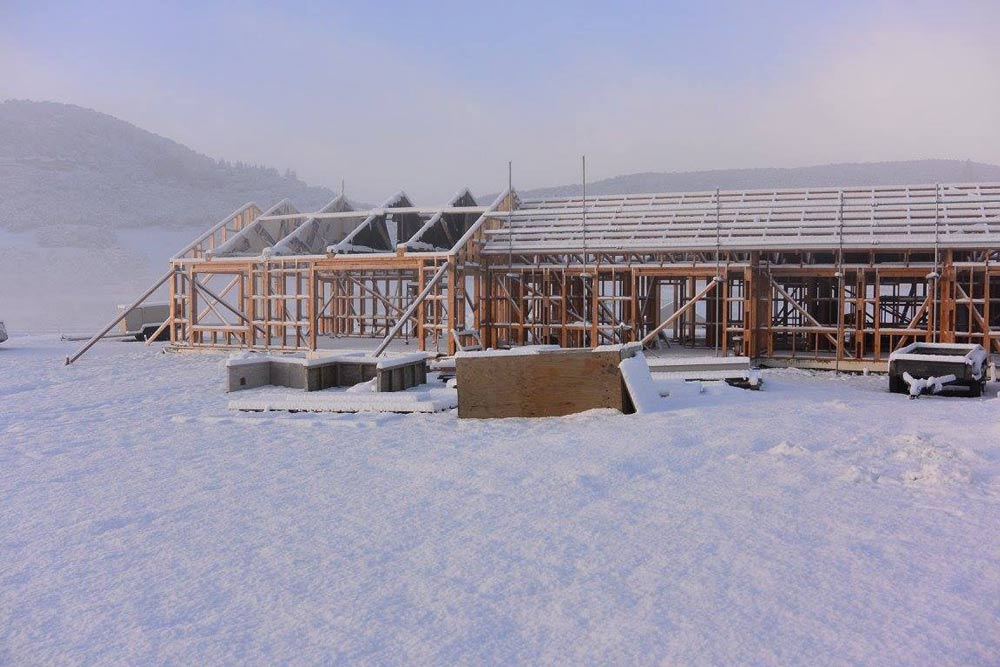 wooden house frame in the snow