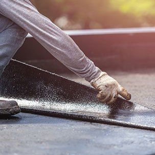 Residential Flat Roofs — Installing tar foil on the rooftop of building in Red Bank, NJ