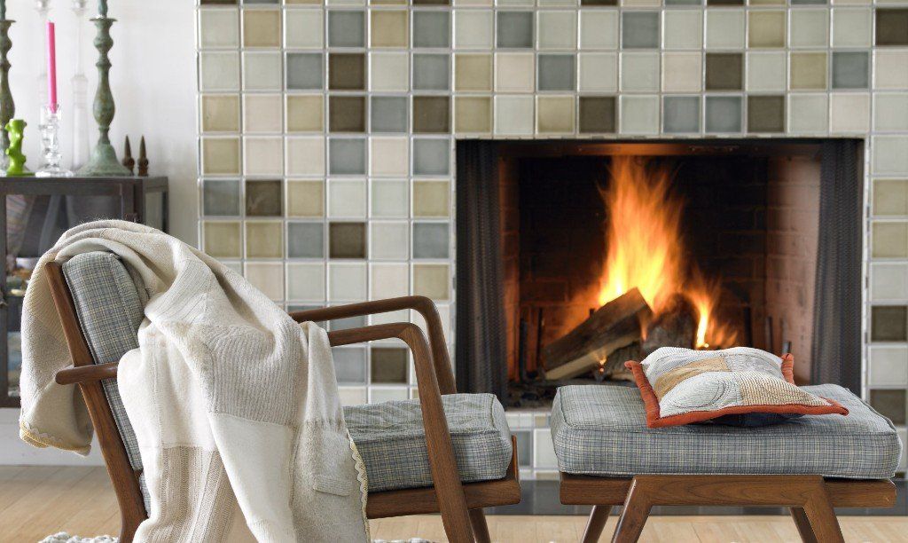 fireplace in the living room with two chairs in front