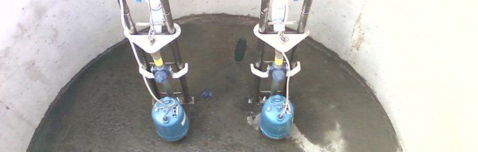 Two robotic arms with blue attachments are inside a concrete structure, likely working on the floor.