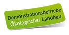 Ein grüner Button mit der Aufschrift „Demonstrationsbetriebe Ökologischer Landbau“