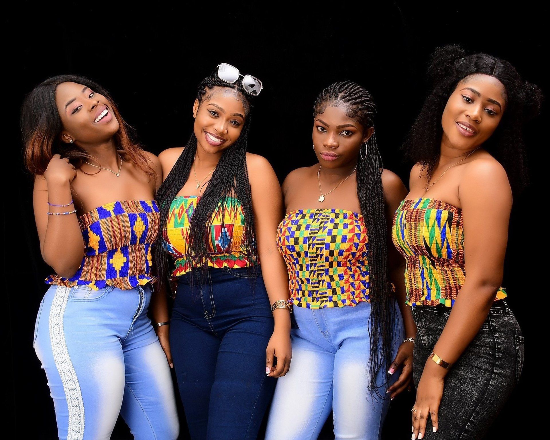 A group of four women are posing for a picture together.