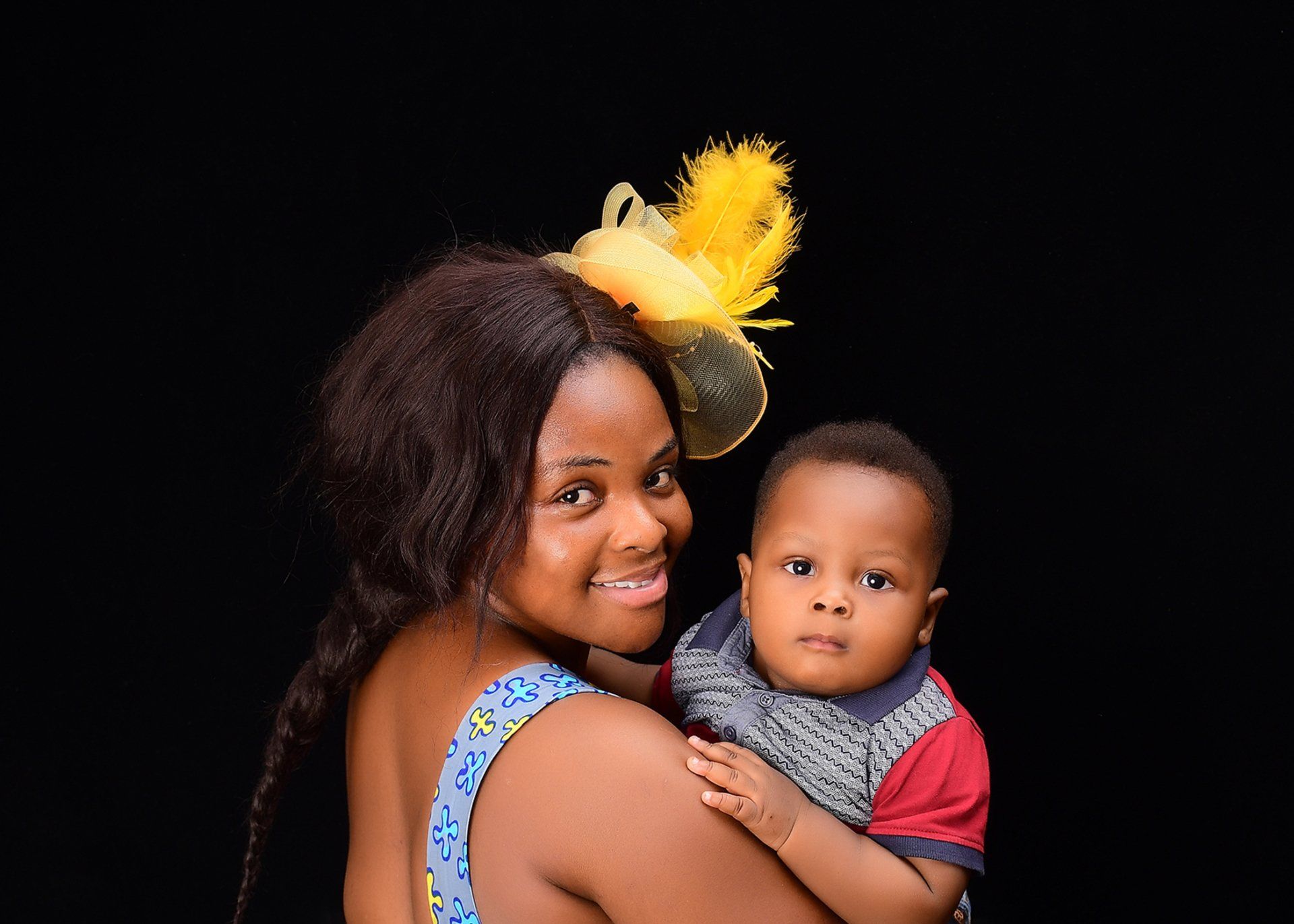 A woman is holding a baby in her arms.
