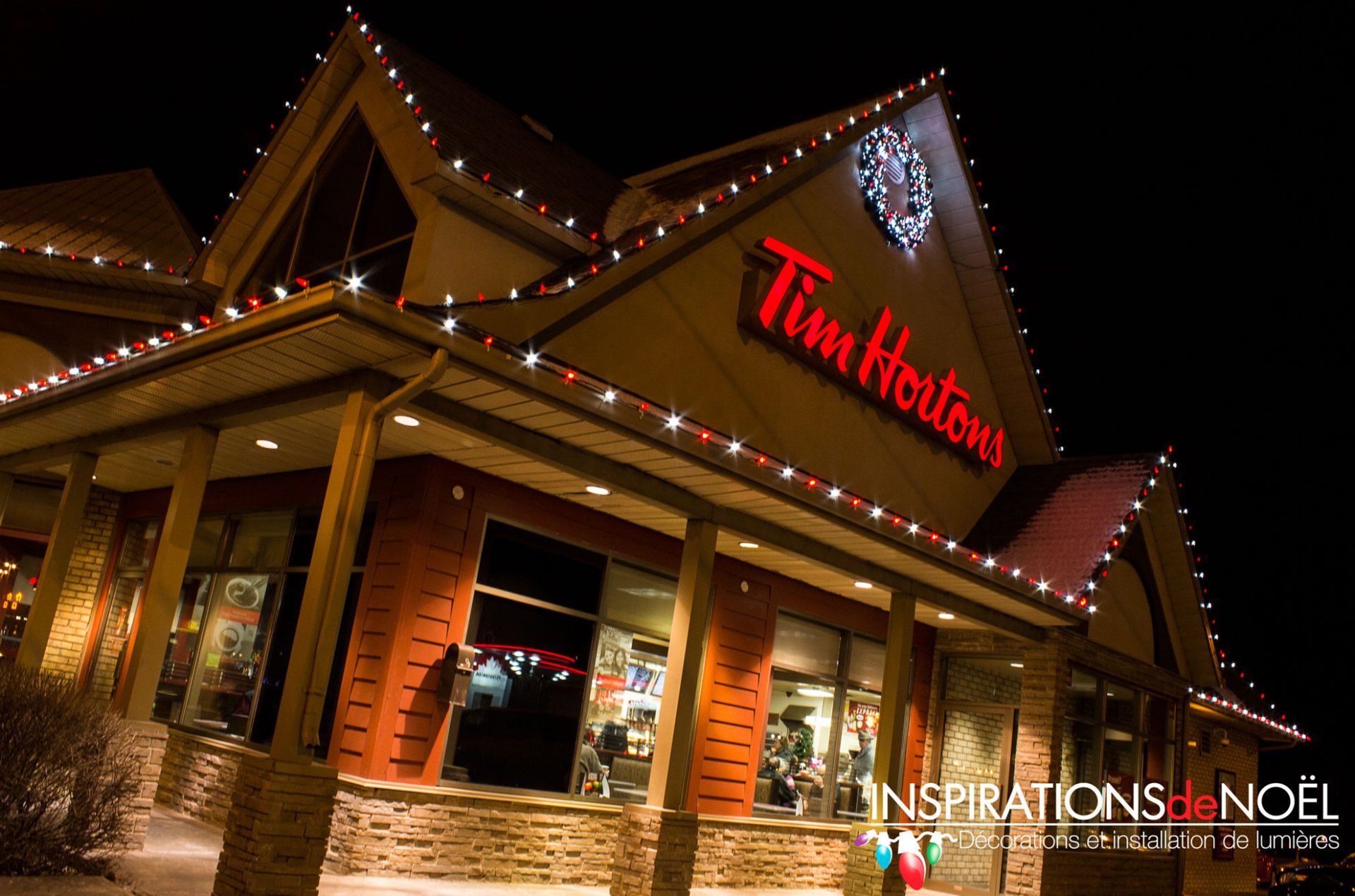 A tim hortons restaurant is decorated with christmas lights