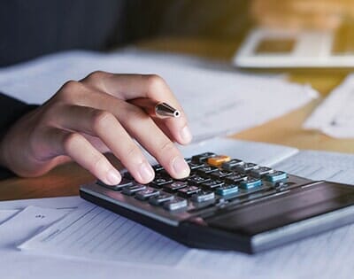 Person working with Calculator — Accountant in Woodstock, IL