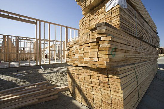 House construction and stack of planks - Lumber Yard in Peoria, IL House construction and stack of planks - Lumber Yard in Peoria, IL