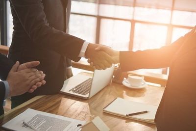 realtor & client handshaking. real estate agent shaking hands with customer. sale & purchase property with signing contract document and approved mortgage loan (realtor & client handshaking. real estate agent shaking hands with customer. sale & purcha