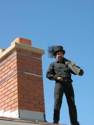 Chimney Flue Cleaning — A Man Standing on the Rooftop in Wasatch Front, UT Chimney Flue Cleaning — A Man Standing on the Rooftop in Wasatch Front, UT