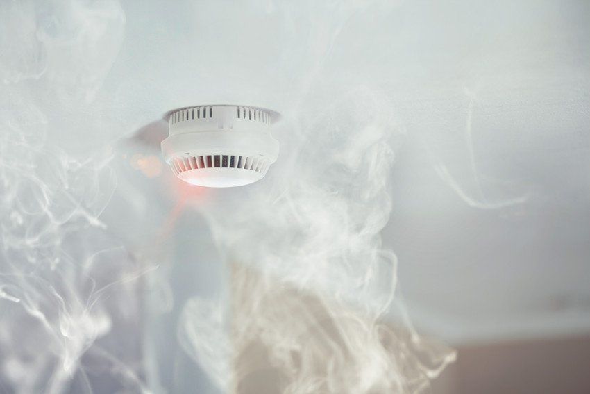 Smoke rises over a smoke detector