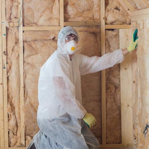 Worker Insulating Walls — Insulation Contractor in Ocean View, NJ Worker Insulating Walls — Insulation Contractor in Ocean View, NJ