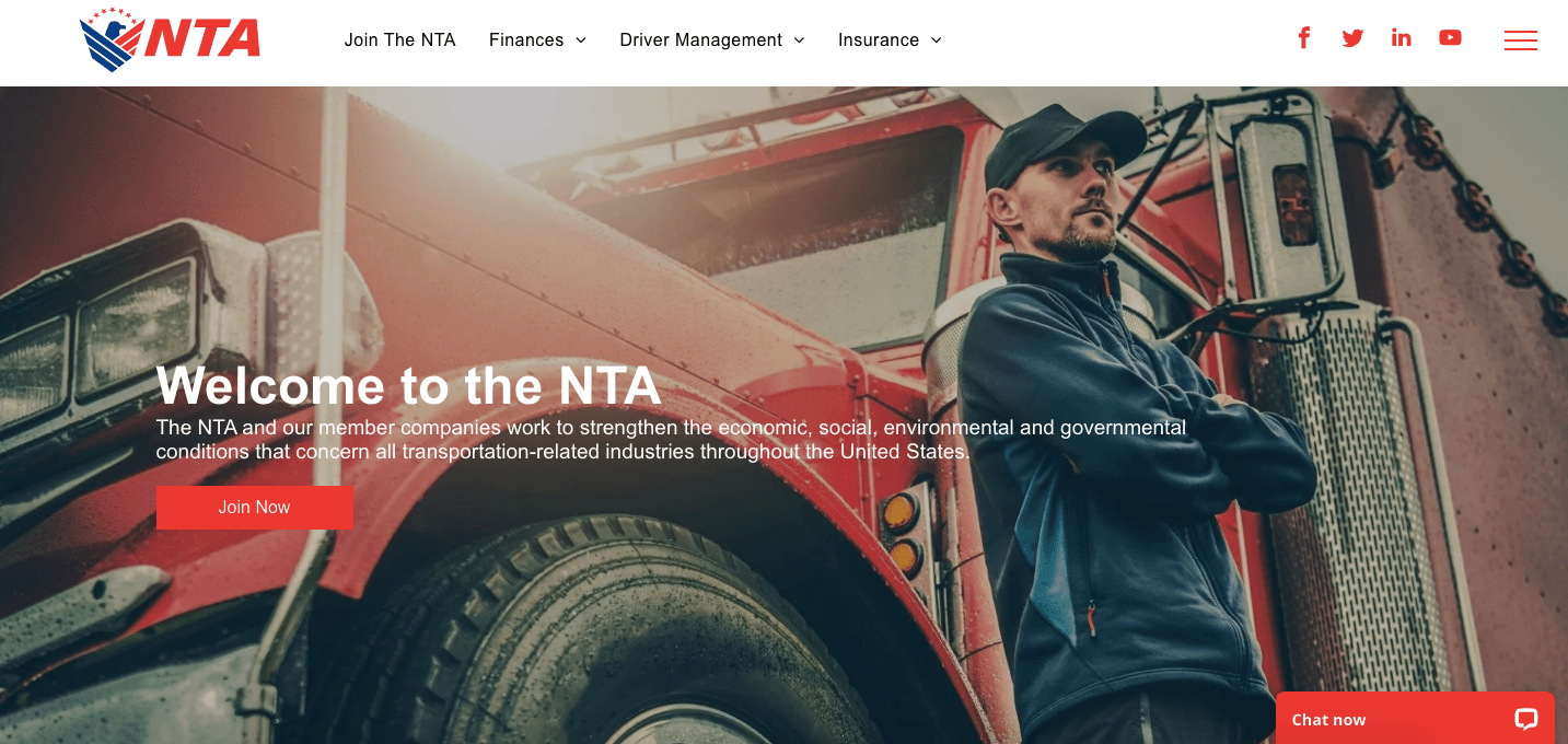 A man is standing next to a red truck on a website.