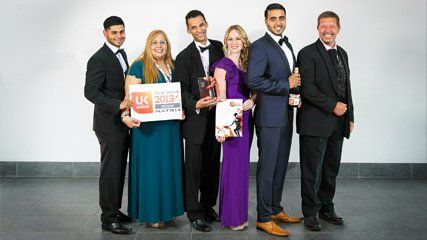 Our team holding award certificates