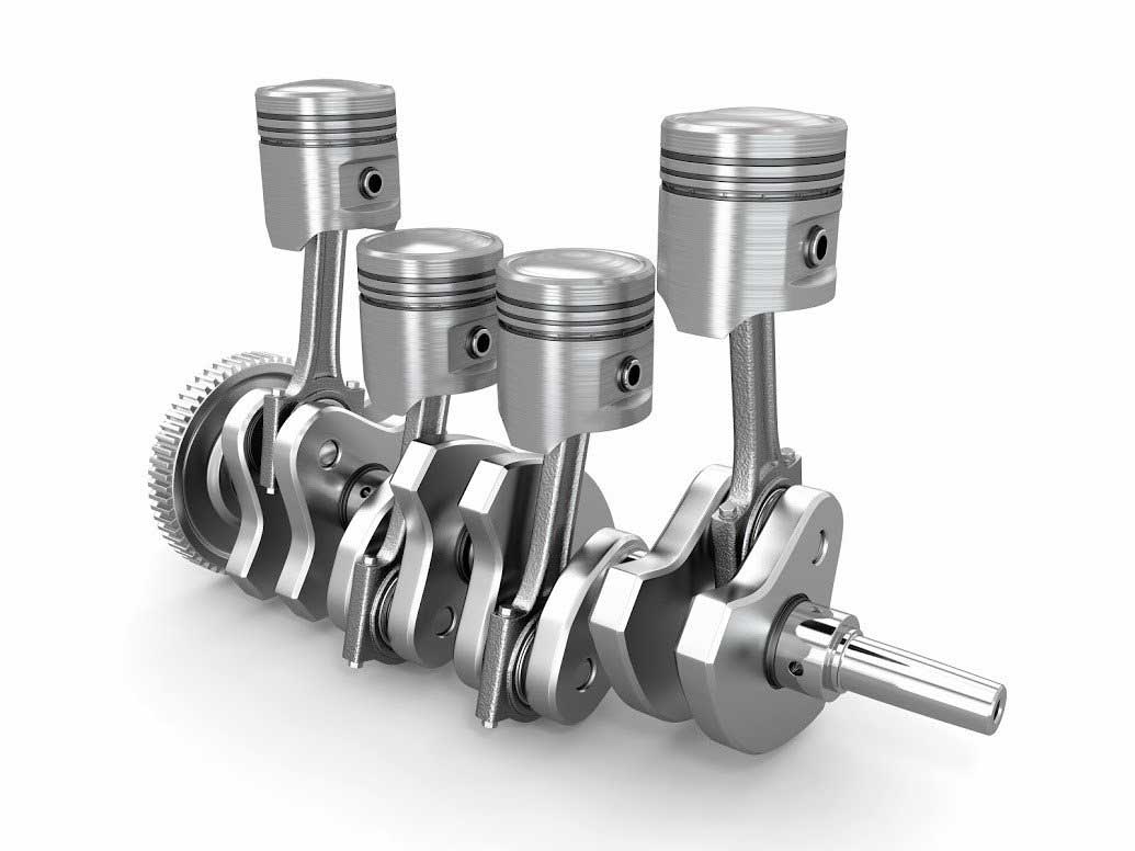 A close up of a crankshaft with four pistons on a white background.
